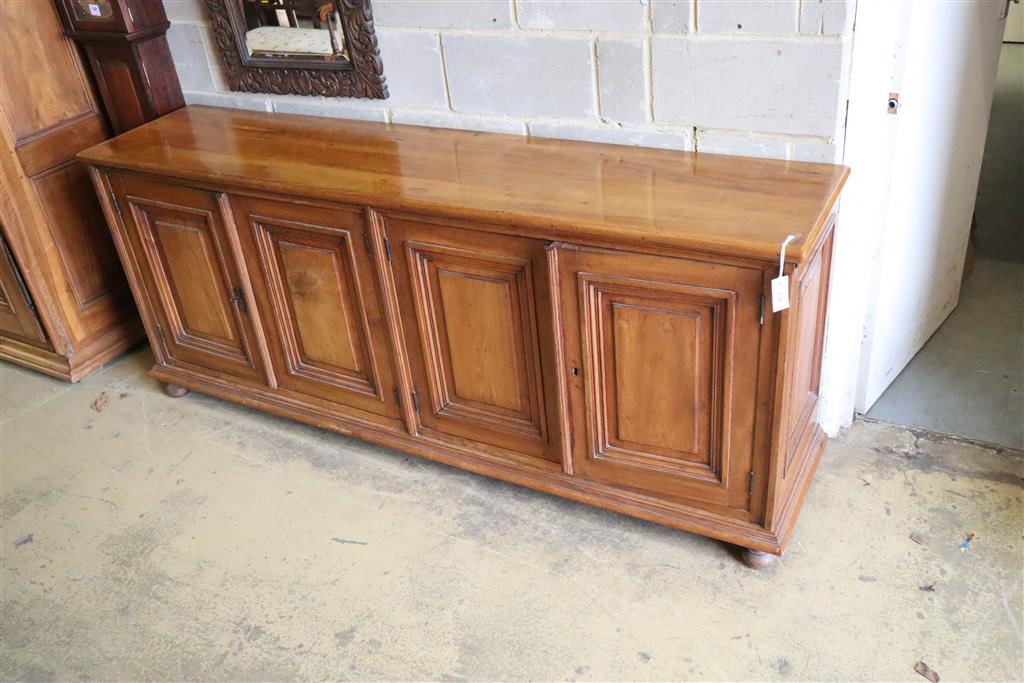 A 19th century French walnut four door panelled cupboard, width 210cm, depth 46cm, height 87cm